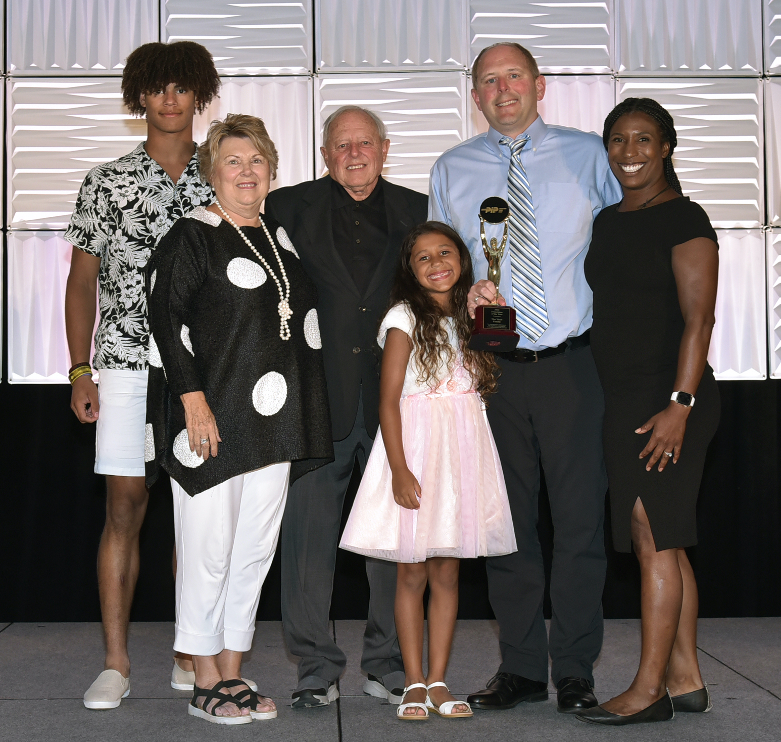 A group of people posing for a photoDescription automatically generated
